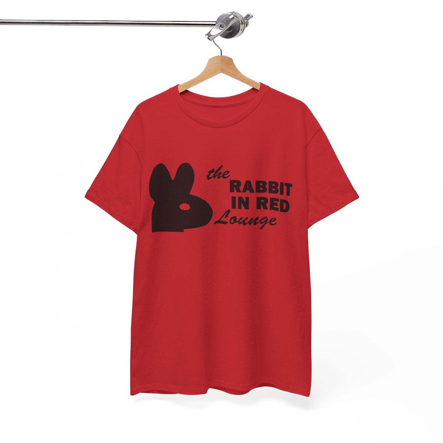 A red short-sleeve t-shirt hanging on a wooden hanger from a metal rail, featuring a black bunny silhouette and the text 'the RABBIT IN RED Lounge' printed on the front.